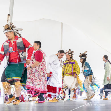 Line of Haudenosaunee dancers performing