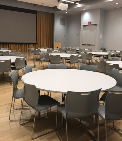 Round tables with ten chairs around them set up in the Seneca Art & Culture Center Auditorium