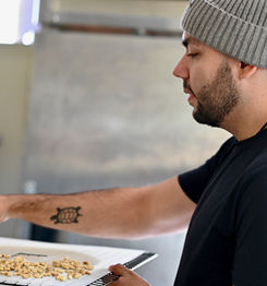 A man holding a tray of corn kernels