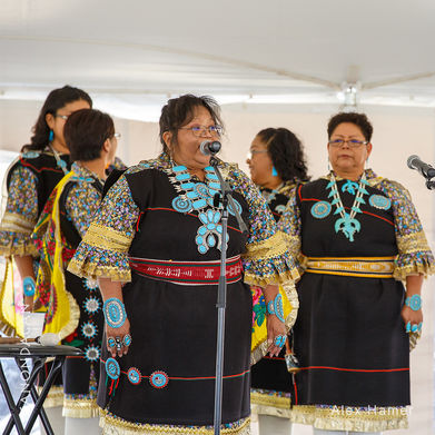 Zuni woman speaking with other women behind her