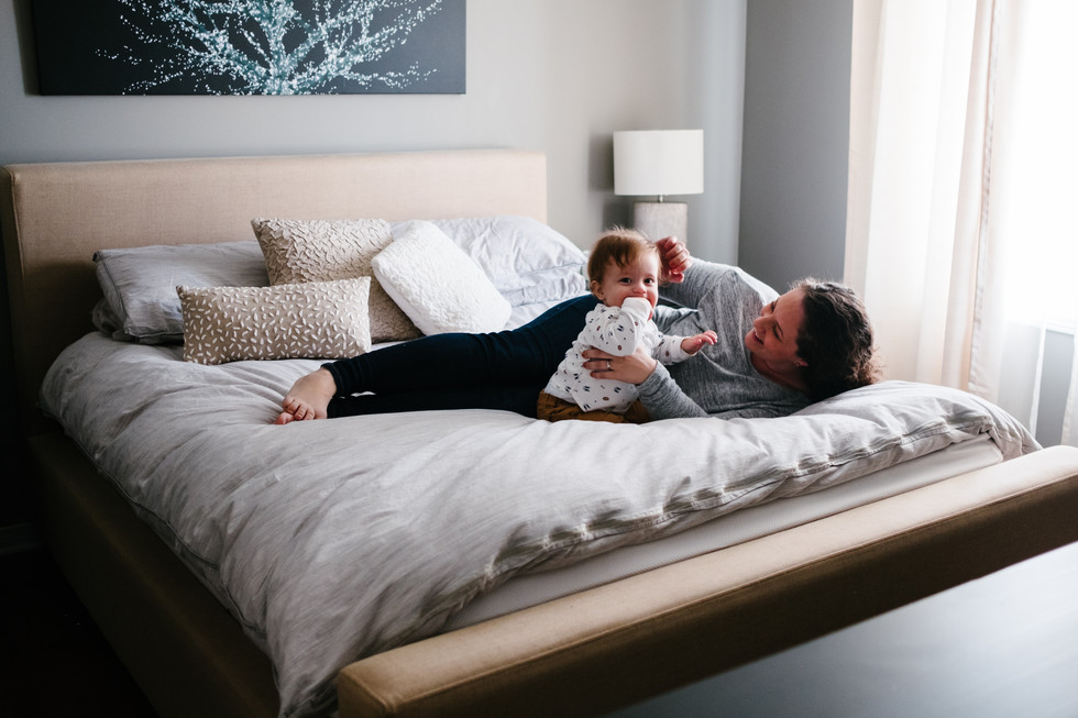 Wide shot of mother lying with son taken during in-home documentary film and photo session in Ottawa Gatineau by photographer Melanie Mathieu.
