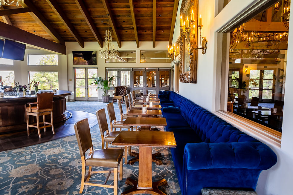 havens country club lounge featuring six televisions, stone fireplace, and window-side seating, and views of the golf course.