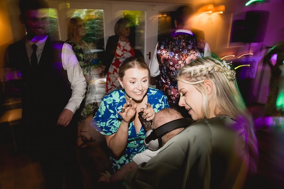 A motion-blurred photo of people dancing at wedding at sheene mill