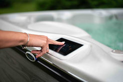 A woman using the touch screen on her luxury hot tub from Hydropool North West.