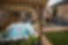 A constant current swim spa with a wooden pergola.