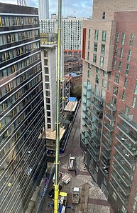 A Hydropool North West hot tub is prepared to be lifted by crane to the top of a skyrise apartment in Manchester City Centre.