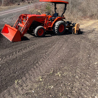 Ribbon Trails & Property tractor and power rake to spread topsoil for landscaping in Rutland County, Vermont.