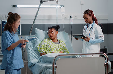 multi-ethnic-team-specialists-consulting-young-patient-with-disease-hospital-ward-medical-