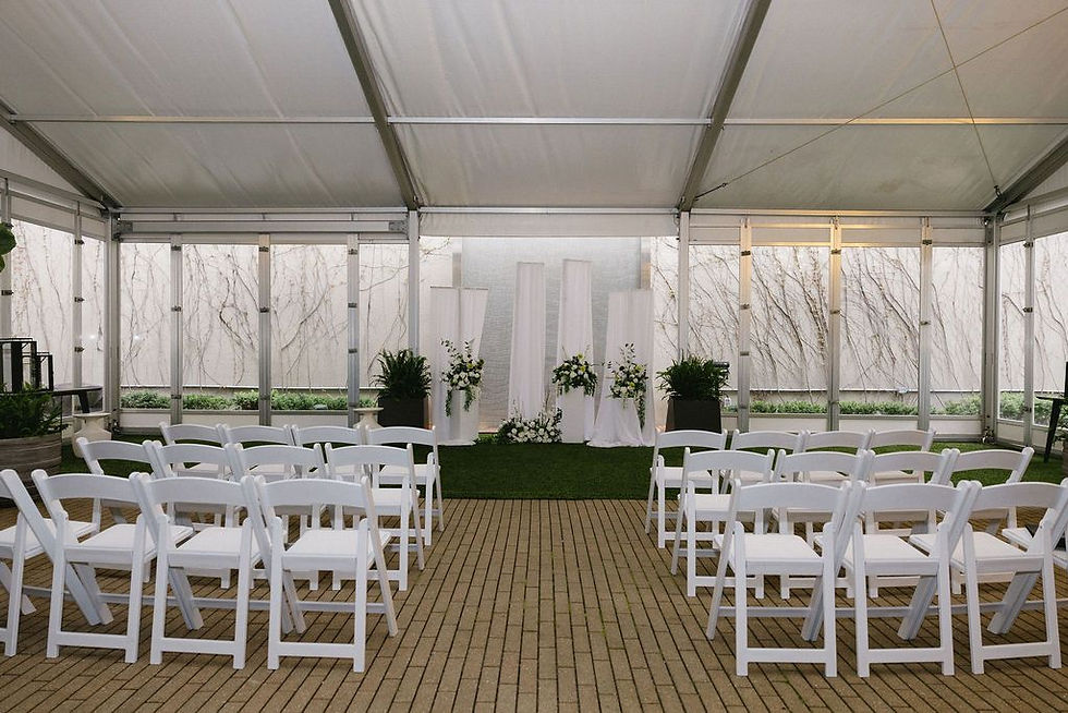 The Westin, wny wedding venues, buffalo weddings, wedding ceremony tent with rows of white chairs facing a floral altar, soft white drapes