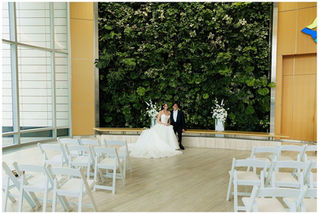 Elegant wedding reception at The Westin Buffalo featuring a modern ballroom with chandeliers, beautifully set tables, floral centerpieces, and a spacious dance floor for a downtown Buffalo wedding celebration.