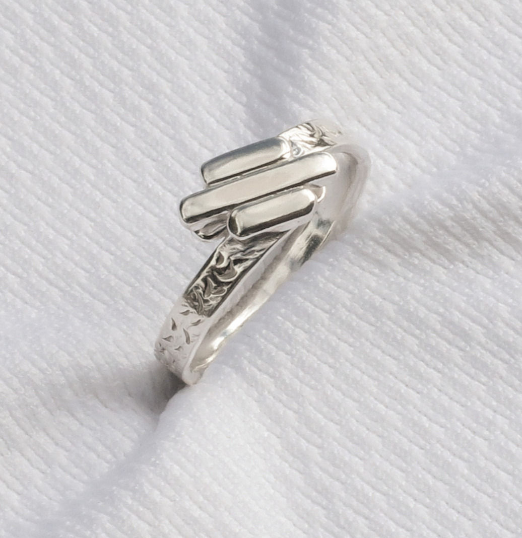 Sterling Silver ring features a hammered band