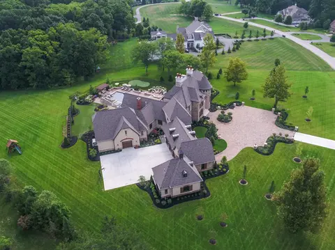 Outdoor Living Space with custom paver patio, pool landscaping, outdoor kitchen, outdoor fire feature in Columbus Ohio done by Ciminello's Landscaping
