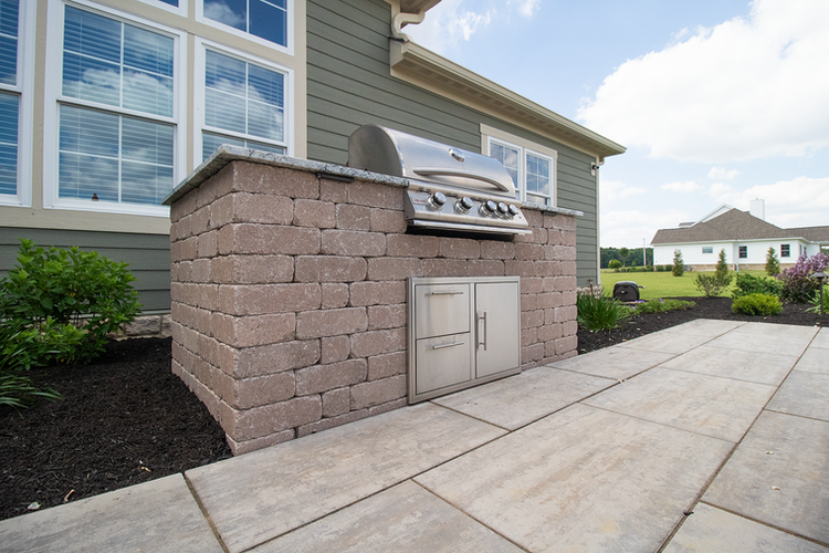 Built-in stainless steel grill with stone island in Sunbury, OH.