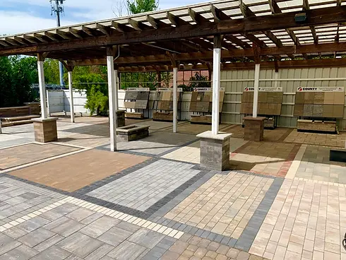 Outdoor patio display with various paver styles under a pergola