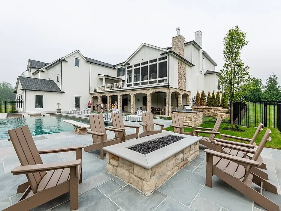 Modern outdoor living space with fire pit and pool.