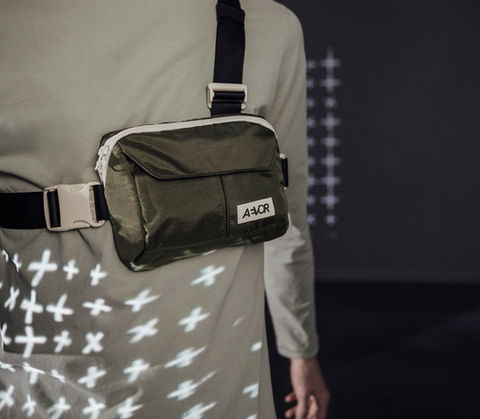 Close-up of AEVOR bag with projected graphic pattern during Keller x AEVOR collaboration shoot.