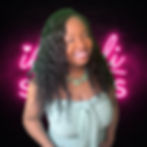 Woman smiling in front of neon iCandi Studios sign, representing confidence, personal growth, and accountability in relationships.