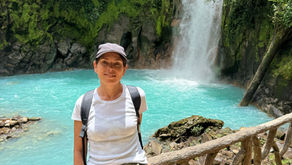 Woman in front of Rio Celeste Waterfall, Costa Rica