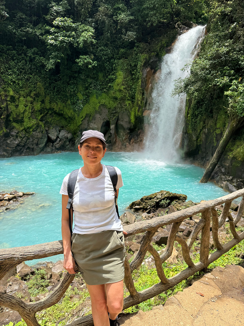 Woman in front of Rio Celeste Waterfall, Costa Rica