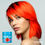 Miniaturbild: Junge Frau mit leuchtend orangefarbenem Haar und La Riche Directions Ultraviolet 100 ml HaarPflegeShop