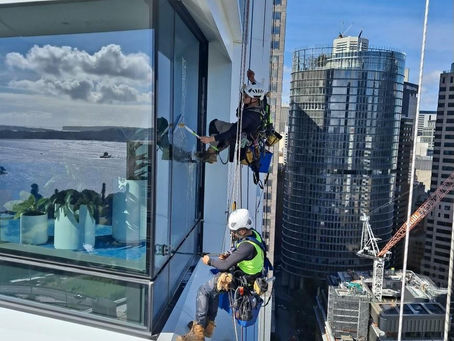 What equipment is used for cleaning windows on tall buildings?
