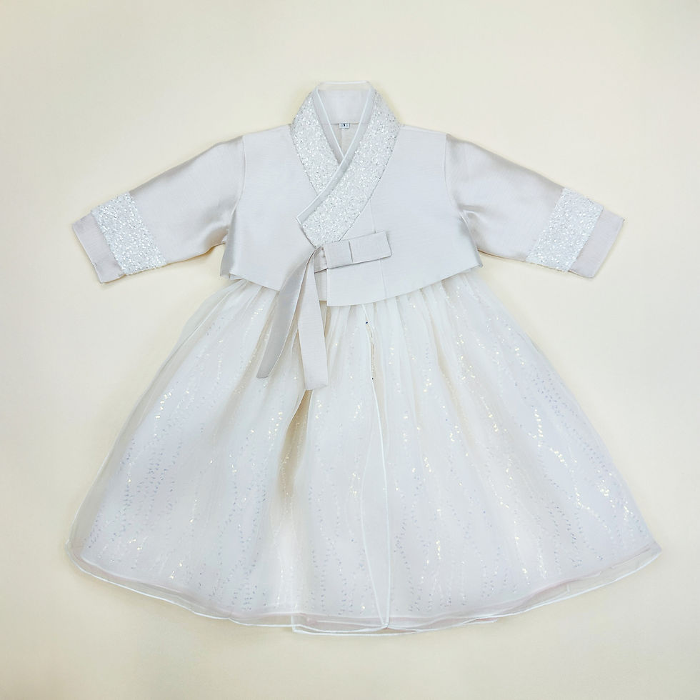 Baby girl hanbok with light ivory jeogori featuring silver glitter trim and a sparkly ivory tulle skirt for first birthday ce