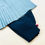 Thumbnail: Traditional baby boy dohl hanbok set with light blue pleated top and navy pants, featuring embroidered round crest details