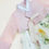 Thumbnail: Baby girl hanbok with soft pink jeogori and ivory chima decorated with colorful wildflower print for first birthday celebrati