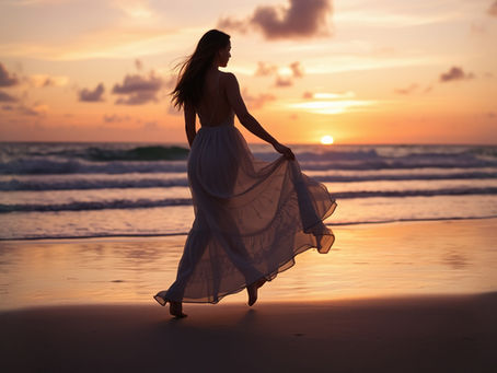 Woman walking on the beach during sunset wearing a beautiful flowing dress and feeling the positive energy of the world.