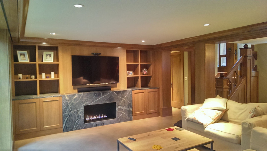 Cozy living room with fireplace, television, and cabinets; Media Room design. Capital Hill Seattle