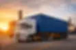 container delivery truck in Dubai industrial area transporting shipping container