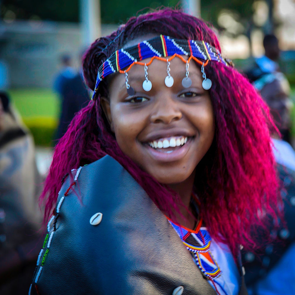 Young Kenyan woman celebrating in trad clothes
