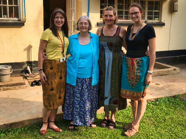 Four women in front of a clinic building