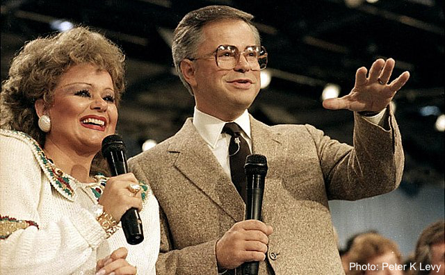 Jim Bakker during a PTL broadcast with his wife Tammy Faye, 1986.