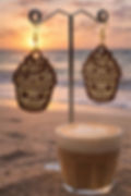 Kawaii laser engraved latte earrings against a sunset beach backdrop