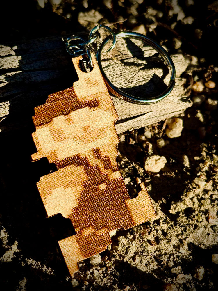 Laser engraved 8-bit Super Mario keyring in an outdoor setting