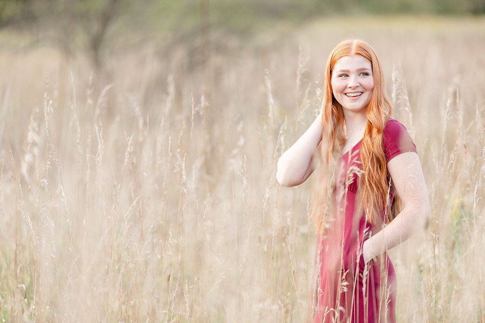 josh and Andrea photography husband and wife team michigan senior photo shoot session al sabo land preserve girl standing smiling in field