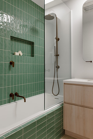 Custom bathroom with green subway feature wall, bronze tapware and Nordic Oak vanity