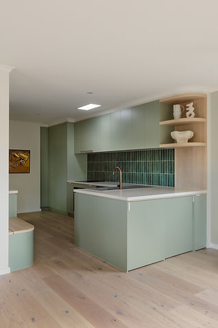 Custom kitchen design in Laminex Bayleaf and Polytec Nordic Oak, with green subway splashback tile