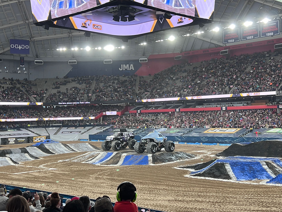 Monster Jam trucks waiting to race around the track