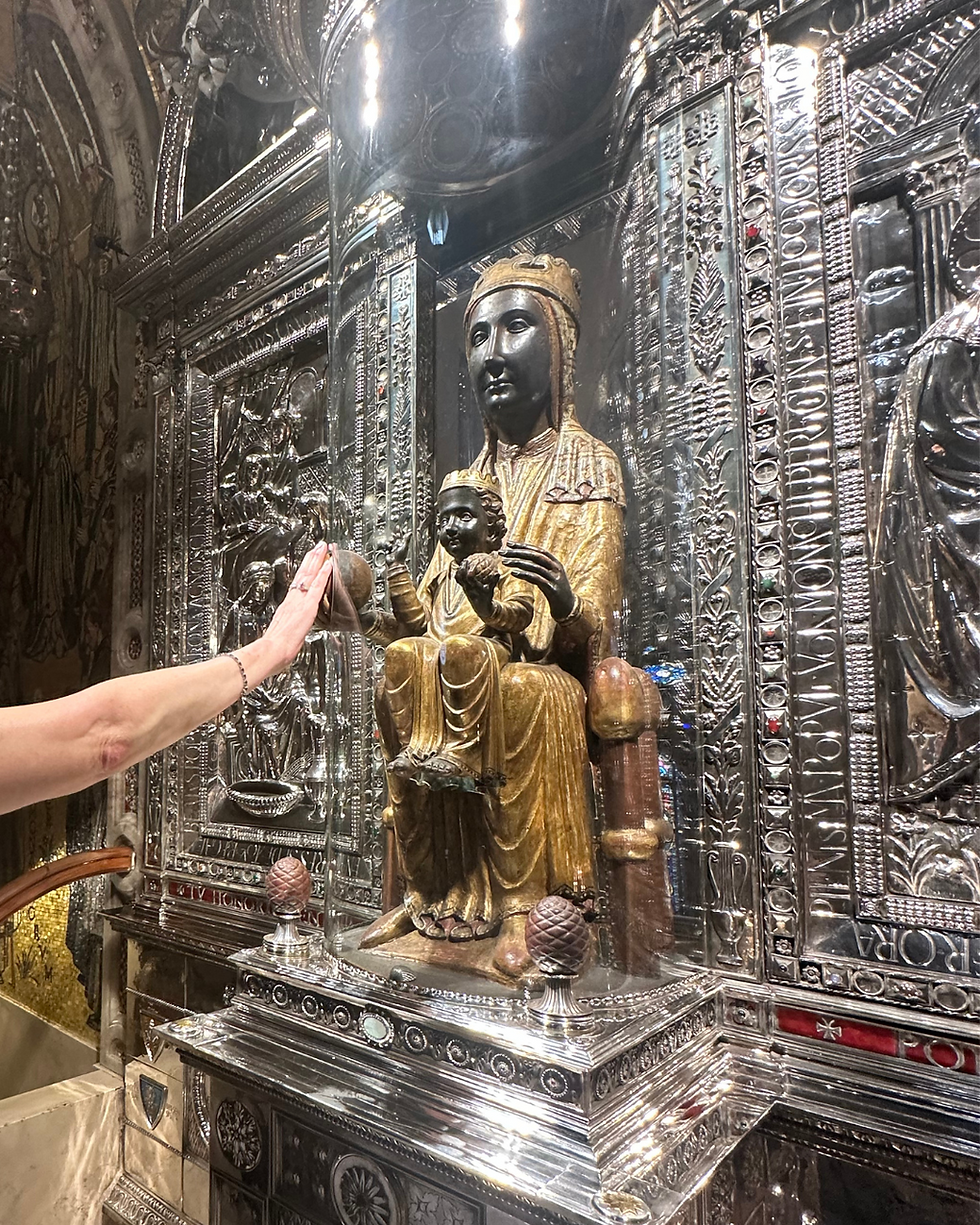 Oracle Maureen touches the sphere of the Black Madonna, honoring the Divine Mother.