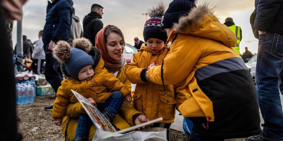 Ukrainian woman with her 3 children receiving food and supplies