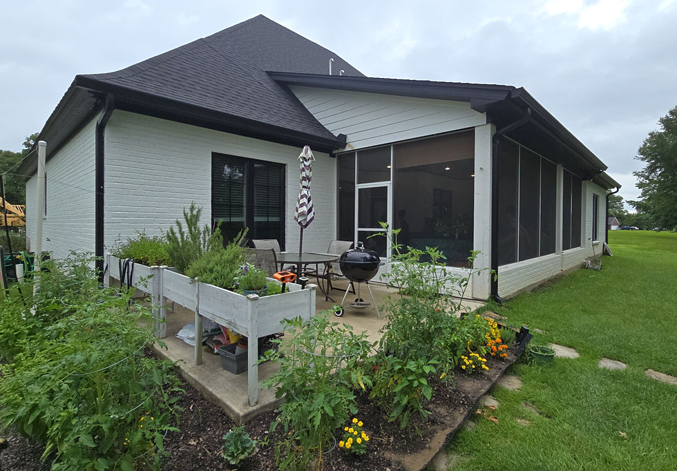 Custom outdoor living space with screened patio and seamless gutters in North Louisiana