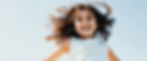 vecteezy_happy-little-girl-with-windblown-hair-smiles-at-the-camera_49488682.jpg