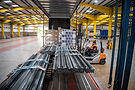 Forklift truck loading freight on to a vehicle in a warehouse