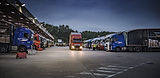 A large yard with lorries lined up