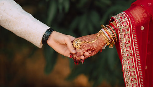 Close-up of held hands during a wedding ceremony