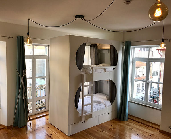 White capsule bunk capsules in a bright shared dorm room at Urban Garden Porto Central Hostel in central Porto