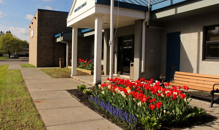 Spring red and white tulips infront of the groton town hall