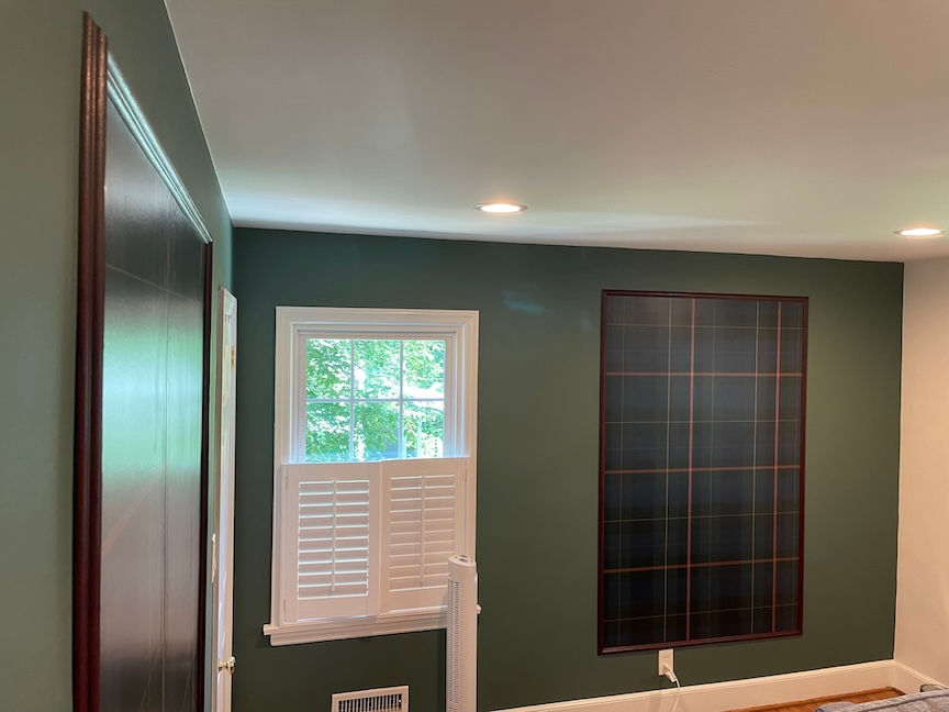 custom home decor nursery walls painted green with framed wallpaper panels by Katie Peña Art in Raleigh, NC